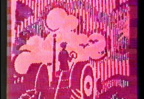 A pink and red still from the video artwork 'Syntax Error in 84 : Part 1 - Machines / Machines' depicting a figure on a tractor.